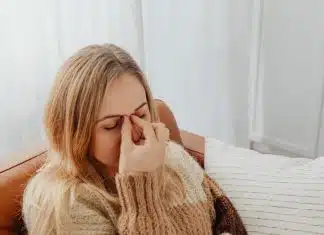 Woman Holding Her Nose Because of Sinus Pain